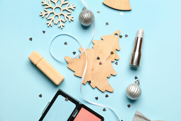 Christmas decor and cosmetics on color background