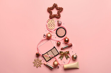Christmas tree made of makeup cosmetics and decor on color background