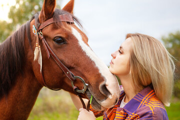 Obraz premium Beautiful young blond woman with a horse, portrait.