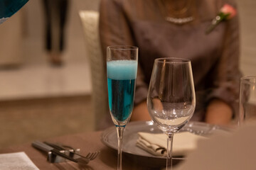 Non-alcohol blue champagne for wedding toast poured into glass in banquet hall in Japan