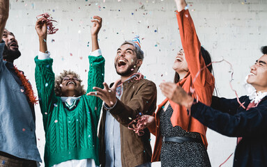 Happy young diverse people celebrating with confetti outdoor - Party concept - Focus on hipster man...