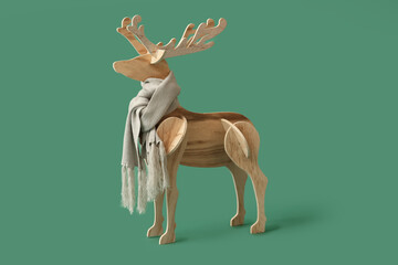Wooden reindeer with scarf on green background