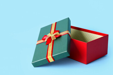 Opened Christmas gift box on color background