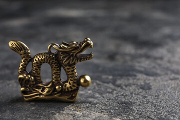 Fototapeta na wymiar Figurine of Chinese dragon on dark background