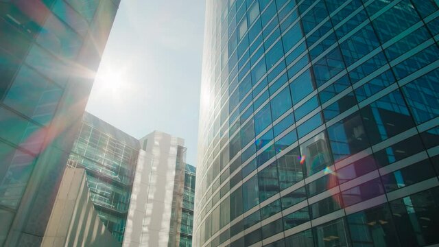 Establishing Urban Panorama of Blue Glass Skyscrapers and Office Buildings in Paris Downtown, France on sunny day. Business, Corporate Architecture or Finance Banking Concept. 4K Wide b-roll shot