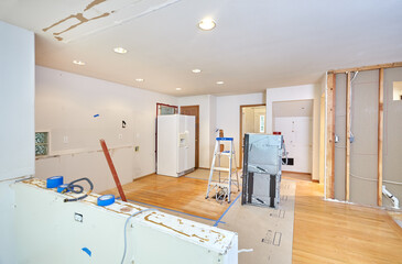 Old kitchen cabinets, counter, island and appliances removed in preparation for remodeling