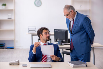 Two male colleagues working in the office