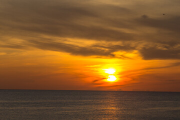 The background of the sea by the evening sea, with natural beauty (sea water, rocks, sky) and fishermen are fishing by the river bank, is a pleasure during travel.