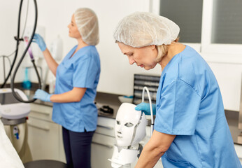Fototapeta premium Skilled female cosmetologists at the medical center are preparing operating room. High quality photo