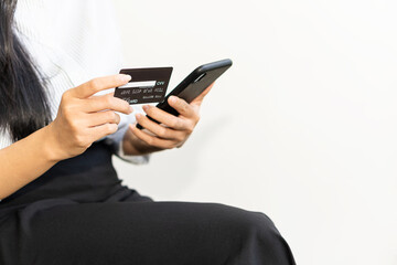 young woman holding credit card and using a laptop computer online shopping, e-commerce, internet banking, spending money, work from home concept and online payment close