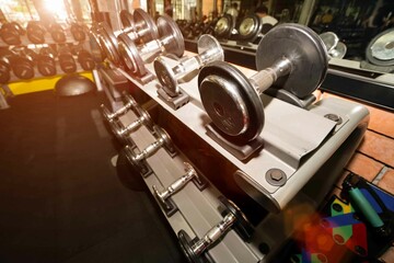 Fitness dumbbells, weights equipment, selective focus,Workout training do muscle building exercises using dumbbells,modern interior of place workout.Gym sport fitness concept.