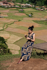 Fototapeta premium Happy young woman traveler standing with raised arms and enjoying a beautiful nature