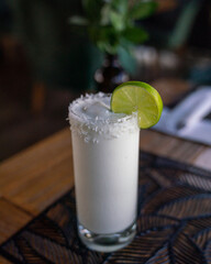 refreshing white cold shake drink with coconut and lime from colombian restaurant