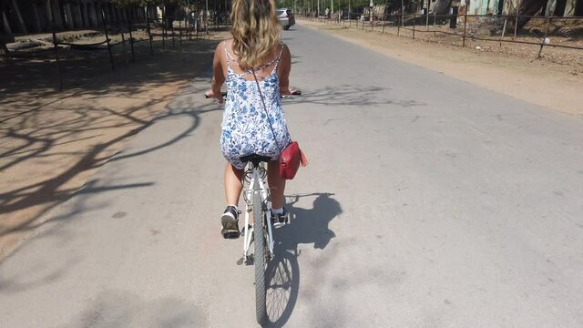 Tourist Cycling Through Ruins of Hampi, Karnataka, India.