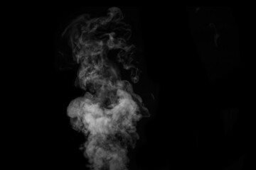 Fragment of white hot curly steam smoke isolated on a black background, close-up. Create mystical...