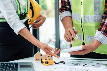 Two engineers are consulting on building design. Teamwork success is a technique of successful work.