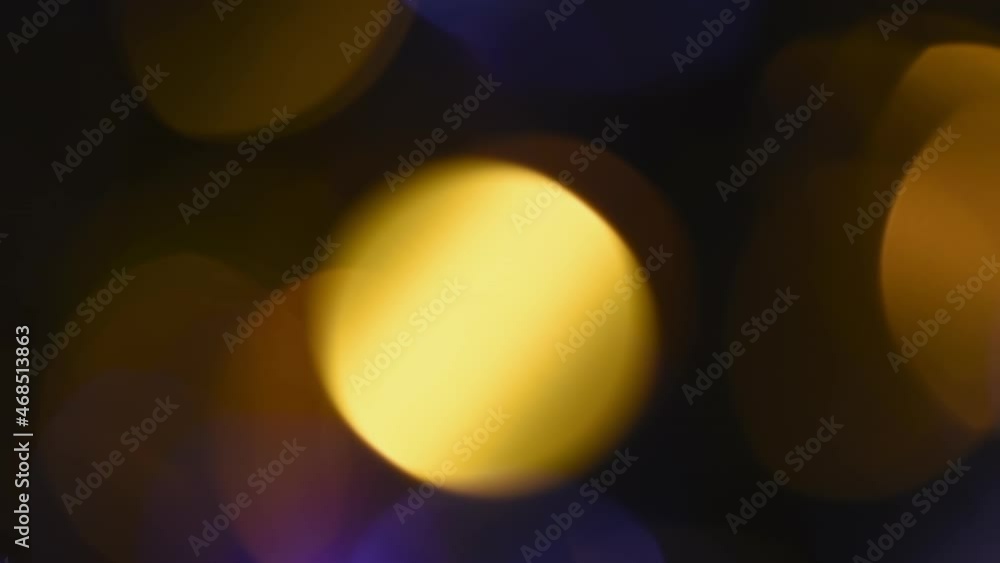 Canvas Prints bright golden bokeh motion. beautiful round bokeh of gold and blue colors movement on a black backgr