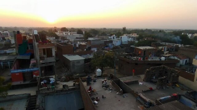 Poverty and garbage in area of Dooni city, Rajasthan. Aerial rising at sunset
