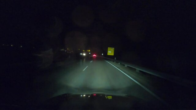 Driving through the bavarian capital Munich at night pov drivers view