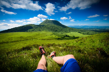 Puy de Dome mountain and hikers legs, Auvergne