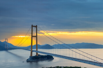 modern suspension bridge in sunset