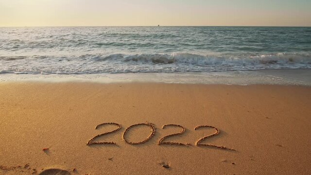 2022 year on the sea shore during sunset. 
