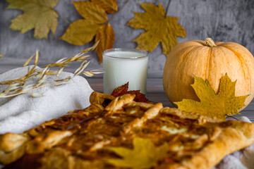 Cooked pumpkin pie for Thanksgiving day, over white wooden table, rustic style