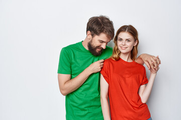 Fototapeta premium a young couple multicolored t-shirts communication quarrel studio lifestyle