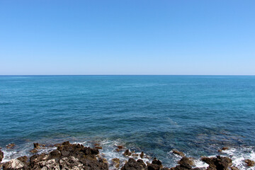 background of beautiful photography of the rocky coast of the clear blue sea