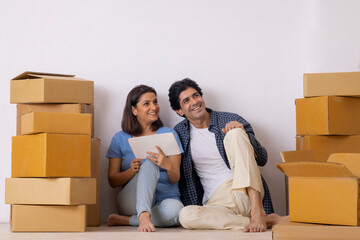 Indian middle age couple planning together for new ideas on the decoration of new room