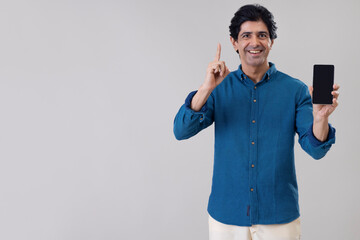 Fototapeta premium Indian man showing his smartphone in front of camera