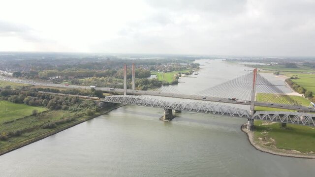 Dr. W. Hupkesbrug and Martinus Nijhoffbrug aerial drone view highway infrastructure bridge over a large waterway in The Netherlands. Zaltbommel