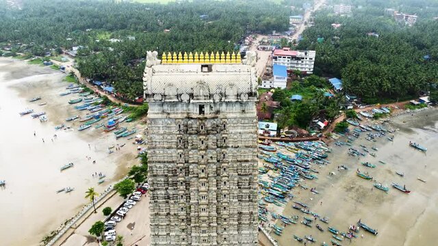 Aerial view of Gopuram, Murudeshwara, Karnataka (India) surrounded by Arabian sea. This clip was captures in morning and offers mesmerizing view of one of the finest ancient architecture.