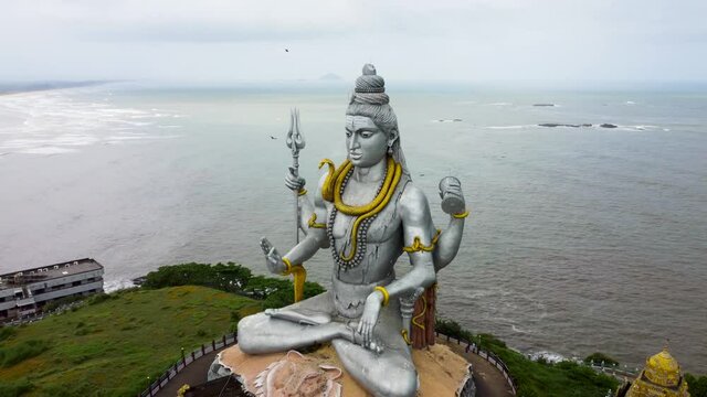 Mesmerizing aerial view of world's second highest Lord Shiva Statue surrounded by Arabian sea. This place is located in Murudeshwar, Karnataka (India).