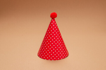 Colorful birthday cap on brown  background.