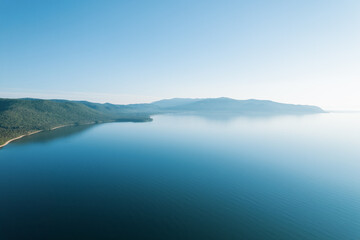 Summertime imagery of Lake Baikal is a rift lake located in southern Siberia, Russia Baikal lake summer landscape view from a cliff near Grandma's Bay. Drone's Eye View.