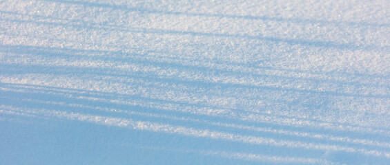 Shadow from trees on the snow as an abstract background.