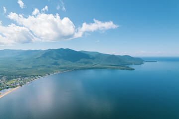 Summertime imagery of Lake Baikal is a rift lake located in southern Siberia, Russia Baikal lake summer landscape view from a cliff near Grandma's Bay. Drone's Eye View.