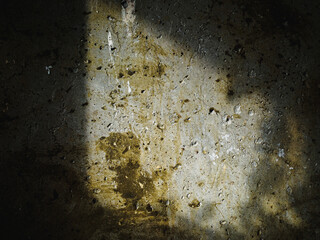Textured concrete background with many potholes, scratches, irregularities, scuffs with colored traces. Horizontal. shadow