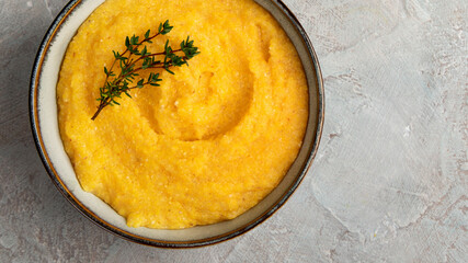 Corn polenta on gray background.