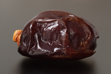 Dried dates on a black background.