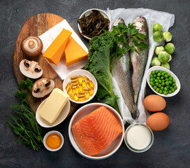Foods high in vitamin D on dark background.