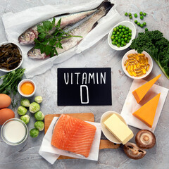 Foods high in vitamin D on light background.