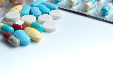 Pharmaceutical medicine pills, tablets and capsules over white background