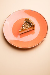 Slice of cheesecake with nuts on a plate