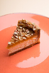 Slice of cheesecake with nuts on a plate