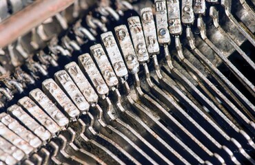 Abstract background with metal part and elements of an old typewriter, selected focus