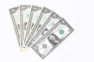 One dollar bills lie fanned out on a white background. Money background. Top view, flat lay. Selective focus.