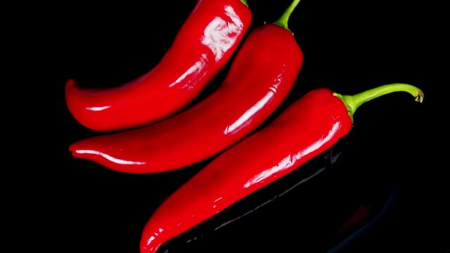 Hot red chili pepper on a black background. Harvest of red pepper.