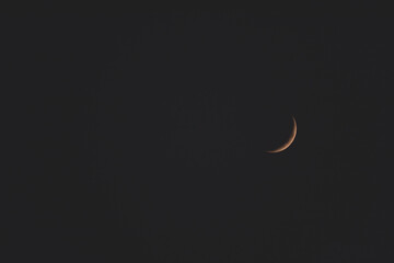The crescent moon on a dark night in black and white